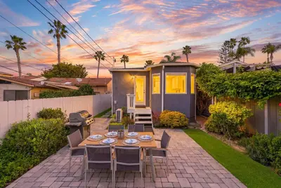 a patio with a table and chairs and a house at Newly Renovated Pacific Beach Home with Private Yard and AC in San Diego