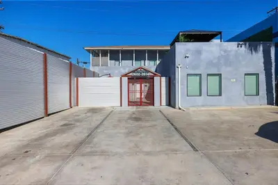 a garage with a red door in front of a building at Harborside Suite 08 with Hot Tub in San Diego