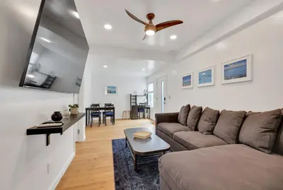 a living room with a couch and a ceiling fan at Harborside Suite 06 with Hot Tub and King Beds in San Diego