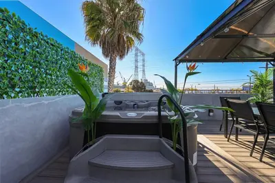 a hot tub on a patio with a palm tree at Harborside Suite 04 with Hot Tub and King Bed in San Diego