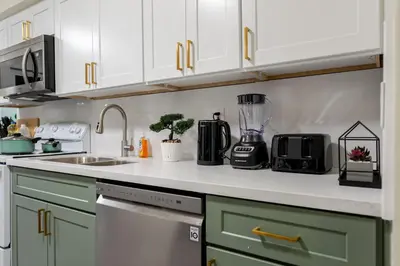 a kitchen with green cabinets and a blender on the counter at Entire Private Home with 4 Bedrooms 2 Bathrooms, Spacious, Lux King Bed, Ranch Style, Prime Area, Available Now in La Mesa