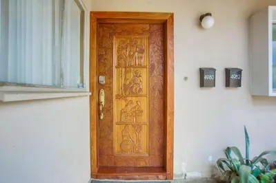 a wooden door with a painting on it at Rooftop patio ocean views surf break steps away in San Diego