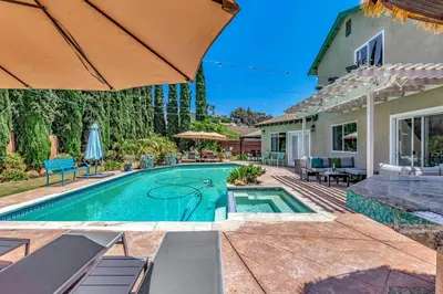 a swimming pool in the backyard of a house at Tropical Bliss - 5BR Pool Spa Games 12 min to dwtn in San Diego