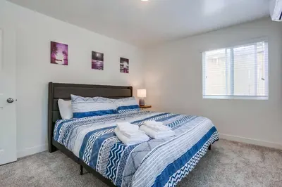 a bedroom with a bed with two towels on it at ocean views 3 blocks to beach AC downstairs in San Diego