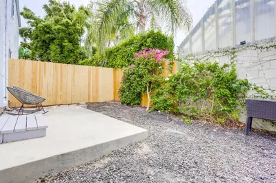a bench sitting next to a fence with pink flowers at ocean views 3 blocks to beach AC downstairs in San Diego