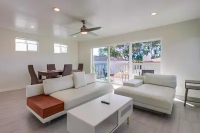 a living room with a white couch and a table at ocean views 3 blocks to beach AC downstairs in San Diego