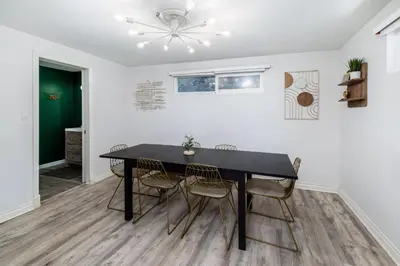 a dining room with a black table and chairs at Downtown La Mesa gem in La Mesa