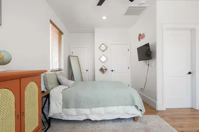 a bedroom with a bed and a tv in it at The Little Oasis in Escondido