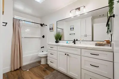 a white bathroom with a sink and a toilet at The Oasis in Escondido