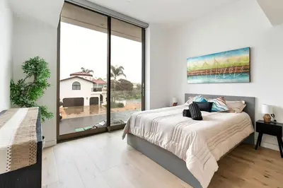 a bedroom with a bed and a large window at Ocean View Luxury Living in Carlsbad