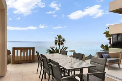 a table and chairs on a balcony with the ocean at La Jolla Suite with Ocean View Patio in San Diego