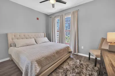 a bedroom with a bed and a desk and a window at Gaslamp 2 bed Penthouse Petco Park Convention Ctr in San Diego