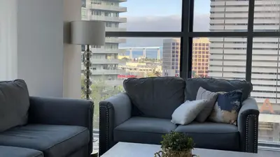 a living room with two couches and a large window at Gaslamp 2 bed Penthouse Petco Park Convention Ctr in San Diego