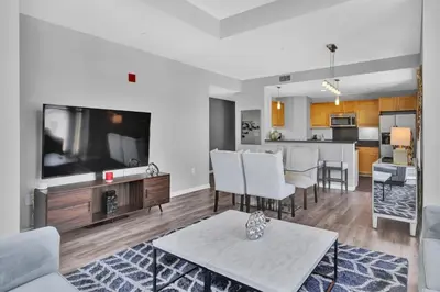 a living room with a tv and a kitchen at Gaslamp 2 bed Penthouse Petco Park Convention Ctr in San Diego