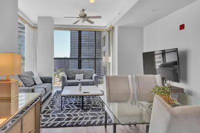 a living room with a couch and chairs and a tv at Gaslamp 2 bed Penthouse Petco Park Convention Ctr in San Diego