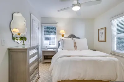 a bedroom with a bed and a dresser and a mirror at half Mi to Balboa Park Cottage with Private Yard! in San Diego