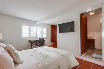 a bedroom with a bed and a desk and a television at Spring break 2 blocks to beach pier Newport Ave in San Diego