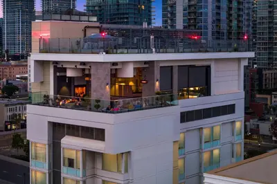 a white building with people on the balcony at Courtyard by Marriott San Diego Gaslamp/Convention Center in San Diego