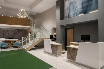 a lobby with a staircase and a desk and chairs at Courtyard by Marriott San Diego Gaslamp/Convention Center in San Diego