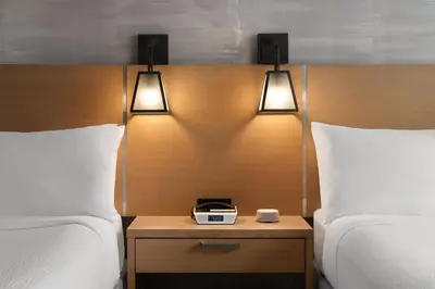 a hotel room with two beds and a clock on a night stand at Courtyard by Marriott San Diego Gaslamp/Convention Center in San Diego
