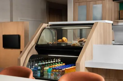 a drink cooler with bottles of drinks in it at Courtyard by Marriott San Diego Gaslamp/Convention Center in San Diego
