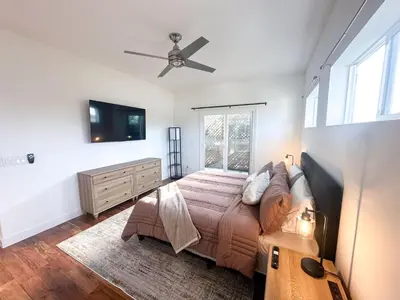 a bedroom with a bed and a ceiling fan at Oceanside Rooftop Retreat Sleeps 4 in Oceanside