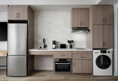 a kitchen with a refrigerator and a dishwasher at Sentral Gaslamp Quarter in San Diego