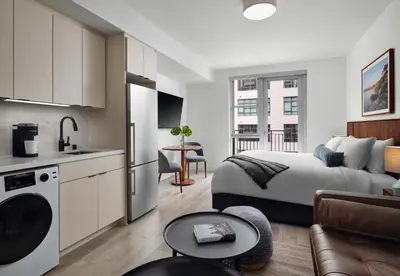 a bedroom with a king sized bed and a kitchen at Sentral Gaslamp Quarter in San Diego