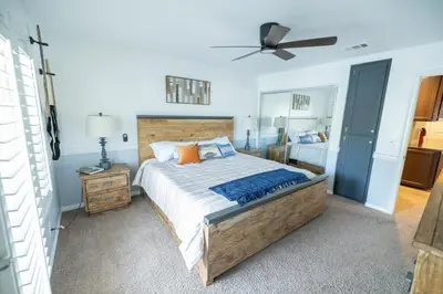 a bedroom with a large bed and a ceiling fan at Wine Country Villa in Temecula