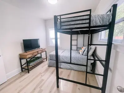 a black bunk bed in a room with a desk at Modern Gem in North Park in San Diego