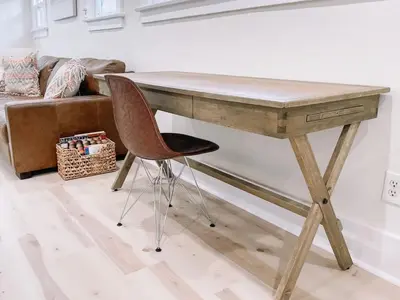 a wooden desk with a chair next to a couch at Modern Gem in North Park in San Diego