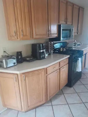 a kitchen with wooden cabinets and a counter top at Big Beautiful Master Bedroom in Bonita