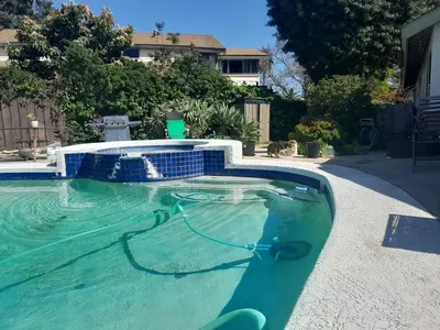 a swimming pool with a hose in the water at Big Beautiful Master Bedroom in Bonita