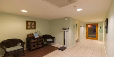 a hospital hallway with two chairs and a desk at Grand Pacific Palisades in Carlsbad