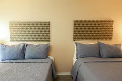 two beds sitting next to each other in a bedroom at Oceanside Beach Condos in Oceanside