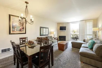a living room with a table and a dining room at Oceanside Beach Condos in Oceanside