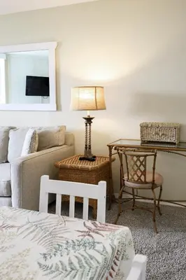 a living room with a couch and a table with a lamp at Oceanside Beach Condos in Oceanside