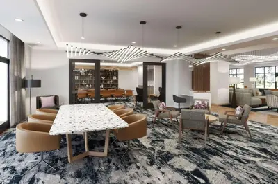 a lobby with a table and chairs and a library at Tempo By Hilton San Diego Del Mar in San Diego