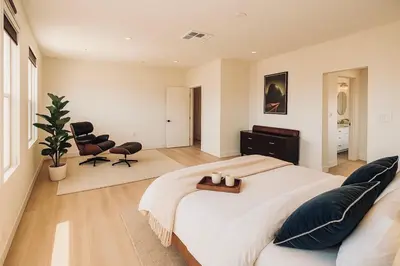 a bedroom with a large bed and two chairs at Situated in the heart of Costa Mesa near 17th Street in Costa Mesa