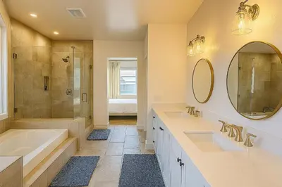 a bathroom with two sinks and a shower at Situated in the heart of Costa Mesa near 17th Street in Costa Mesa