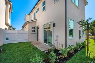 a house with a fence and a yard at Situated in the heart of Costa Mesa near 17th Street in Costa Mesa