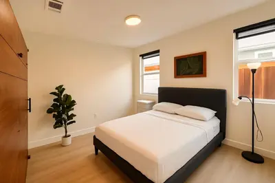 a bedroom with a bed and a potted plant at Situated in the heart of Costa Mesa near 17th Street in Costa Mesa