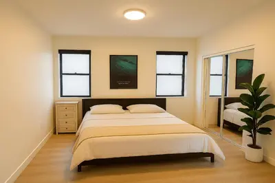 a bedroom with a bed and a potted plant at Situated in the heart of Costa Mesa near 17th Street in Costa Mesa