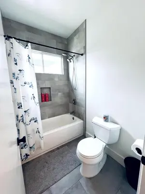 a bathroom with a toilet and a tub and a sink at Situated in the heart of Costa Mesa near 17th Street in Costa Mesa