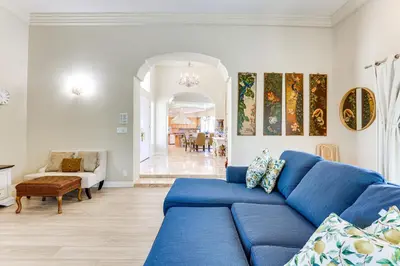 a living room with a blue couch and a table at 3 Mi to Beach Central and Elegant Home in Oceanside in Oceanside