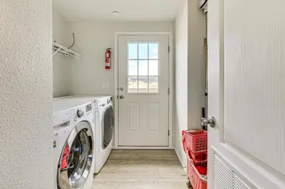a white laundry room with a washer and dryer at Near Ramona Wineries Mtn-View Haven with Large Yard in Ramona