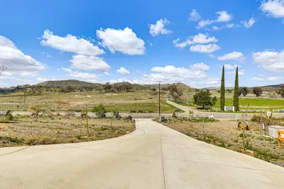 an empty road in the middle of a field at Near Ramona Wineries Mtn-View Haven with Large Yard in Ramona