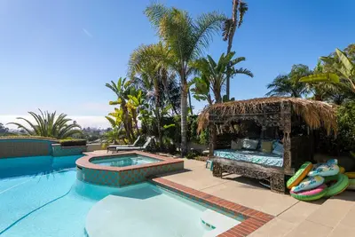a resort swimming pool with a bed and a pool noodle istg at Pool Hot Tubs Views - Castillo de Windsor in San Diego