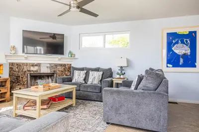 a living room with two couches and a fireplace at Balboa Escape An Iconic Stay in Newport Beach