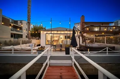 a house with a bridge leading to a patio at Bayside Getaway Waterfront in Newport Beach